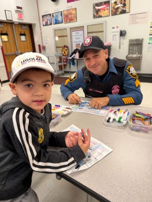 Woodland School student Andrew Santos-Vu participates in Color with a Cop.